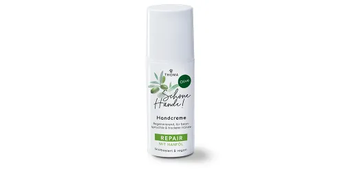 Eine Flasche der Handcreme Schöne Hände Olive von THOMA mit der Kennzeichnung Repair mit Hanföl Die Creme ist biobasiert und vegan wirkt regenerierend und ist ideal für beanspruchte und trockene Hände Nahaufnahme des Pumpspenders